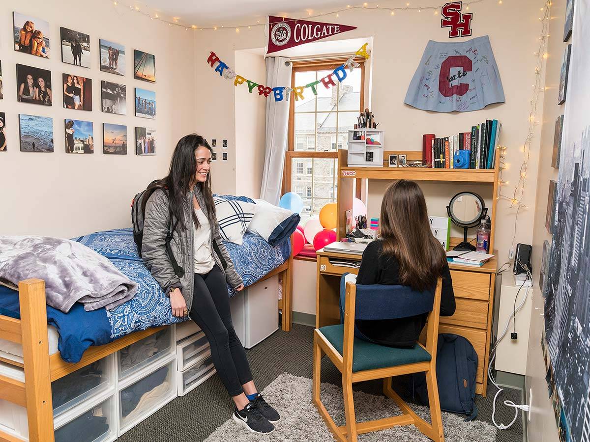 Two students chat in a student bedroom in one of °ϲʹ's Residential Commons